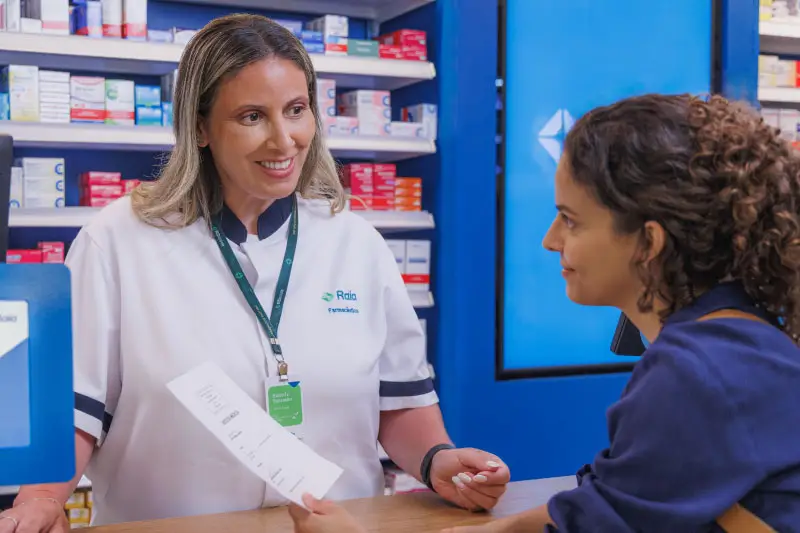 Farmaceutica atendendo uma cliente no balcão da farmácia